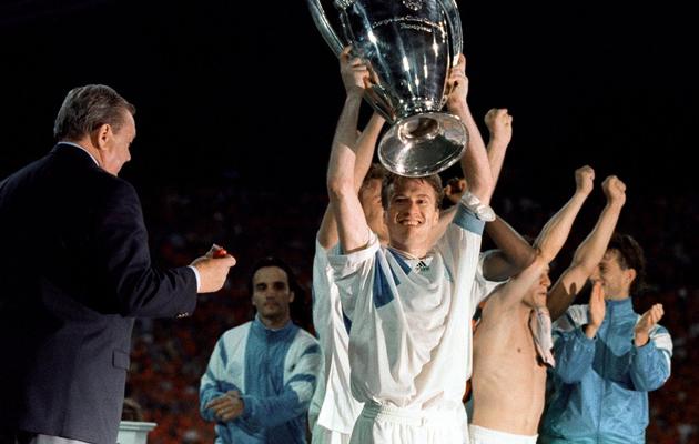 Le capitaine de l'OM Didier Deschamps soulève le trophée de la Ligue des champions, après la victoire contre l'AC Milan (1-0) à Munich, le 26 mai 1993 [Georges Gobet / AFP/Archives]