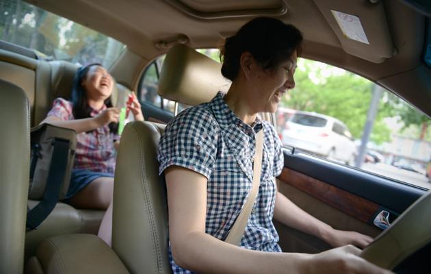 Li Na en voiture avec sa fille Nancy, le 12 mai 2013 à Pékin [Wang Zhao / AFP/Archives]