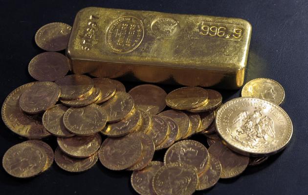 Un lingot et des pièces d'or [Bertrand Guay / AFP]