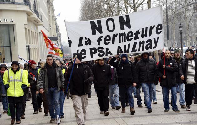Manifestation de salariés de PSA Peugeot Citroën contre la fermeture du site d'Aulnay le 12 février 2013 à Paris [Bertrand Guay / AFP]