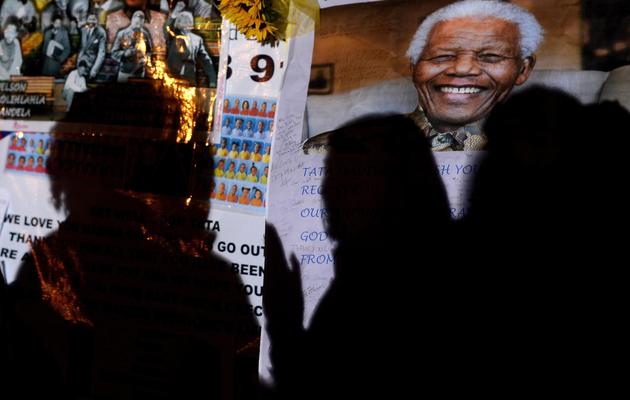 Une photo de Nelson Mandela exposée devant l'hôpital où il est soigné, à Pretoria, le 29 juin 2013 [Filippo Monteforte / AFP]