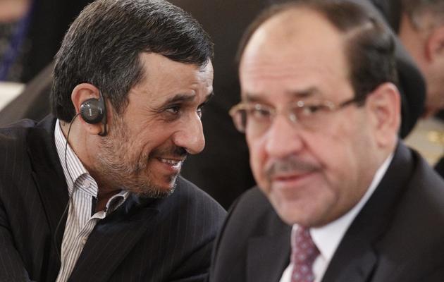 Le président iranien Mahmoud Ahmadinejad (g) et le Premier ministre irakien Nouri al-Maliki lors du Forum des pays exportateurs de gaz, le 1er juillet 2013 à Moscou [Maxim Shemetov / POOL/AFP]