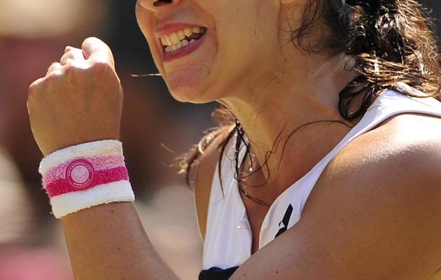 La rage de vaincre de la Française Marion Bafrtoli contre l'Allemande Sabine Lisicki en finale du tournoi de Wimbledon le 6 juillet 2013 à Londres [GLYN KIRK / AFP Photo]