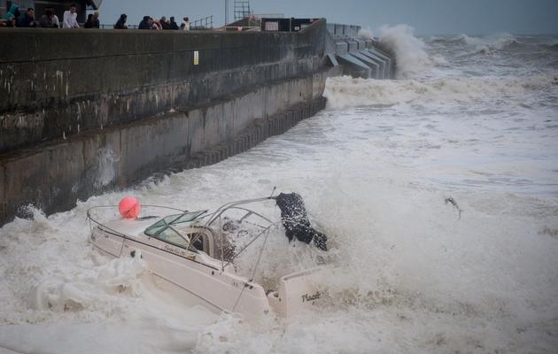Un bateau est emporté par les vagues près de la marina de Brighton, le 27 octobre 2013 dans le sud de l'Angleterre [Leon Neal / AFP]