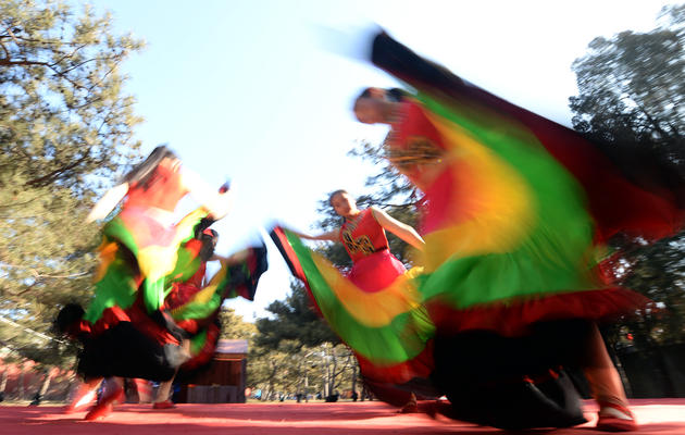 Des danseurs traditionnels du Yunnan sur scène dans un parc de Pékin, le 30 janvier 2014, à la veille du Nouvel an chinois [Goh Chai Hin / AFP]