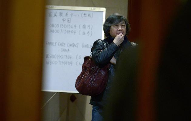 Une parente chinoise des disparus du vol MHR370 de Malaysia Airlines en attente d'information le 18 mars 2014 dans un hôtel de Pékin [Wang Zhao / AFP]
