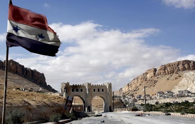 Le drapeau syrien flotte le 18 septembre 2013 sur une route menant à la ville chrétienne de Maaloula [Anwar Amro / AFP]