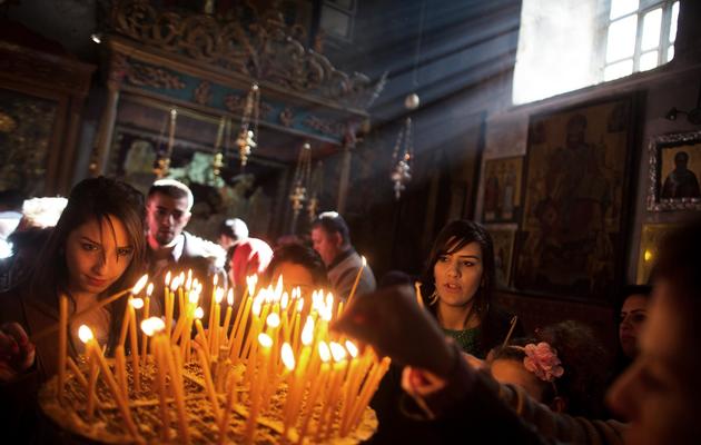 Des fidèles à l'église de la Nativité le 22 décembre 2013 à Bethléem [Menahem Kahana  / AFP/Archives]