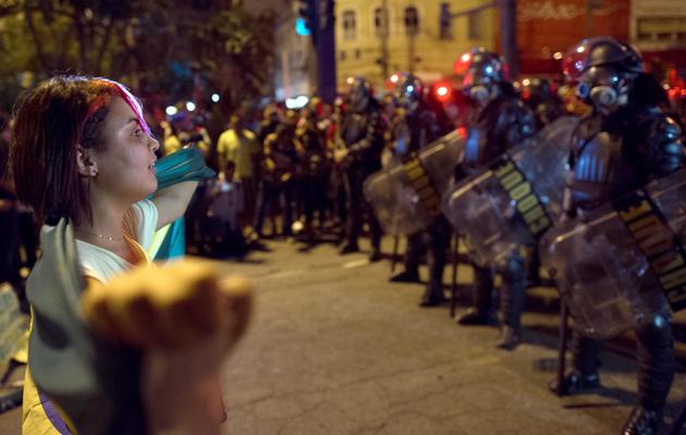 Une manifestante fait face à la police d'élite à Niteroi, à 10 km de Rio de Janeiro, le 19 juin 2013 [ / AFP]
