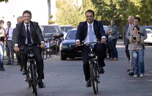 Le ministre du Redressement productif Arnaud Montebourg (g) et le président d'Easybike Grégory Trebaol (d) sur des Solex au Bourget près de Paris, le 5 septembre 2013 [Martin Bureau / AFP]