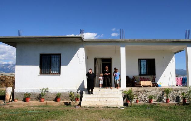Manushaqe Qoku (g) devant sa maison à Vrake, en Albanie, le 21 septembre 2013, aux côtés de ses enfants, Marsela 5 ans, Margarita 15 ans, Marjan 13 ans et Marsel 9 ans (de g à d) [Gent Shkullaku / AFP/Archives]