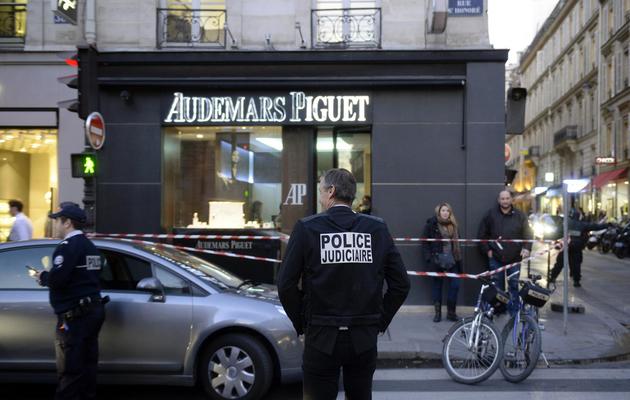 Des policiers devant la bijouterie braquée par un couple rue Saint-Honoré à Paris, le 5 décembre 2013 [Martin Bureau / AFP]