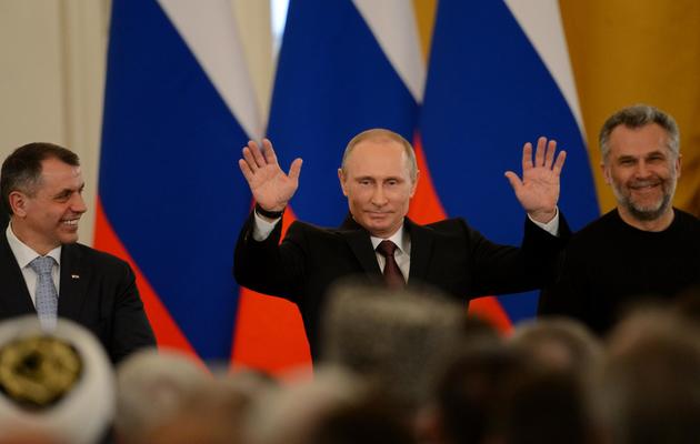 Le président russe Vladimir Poutine (c) après la signature du traité rattachant la Crimée à la Russie au Kremlin à Moscou le 18 mars 2014 [Kirill Kudryavtsev / AFP]