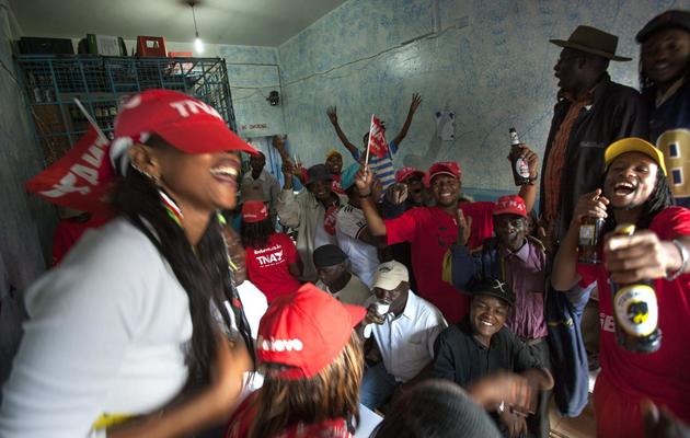Des partisans d'Uhuru Kenyatta célèbrent sa victoire dans un bar de Kawangware, à l'ouest de Nairobi, le 9 mars 2013 [Georgina Goodwin / AFP]