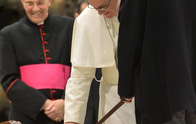 Le pape François caresse le labrador d'un journaliste aveugle, le 16 mars 2013 lors d'une audience privée avec les médias au Vatican [Alberto Pizzoli / AFP]