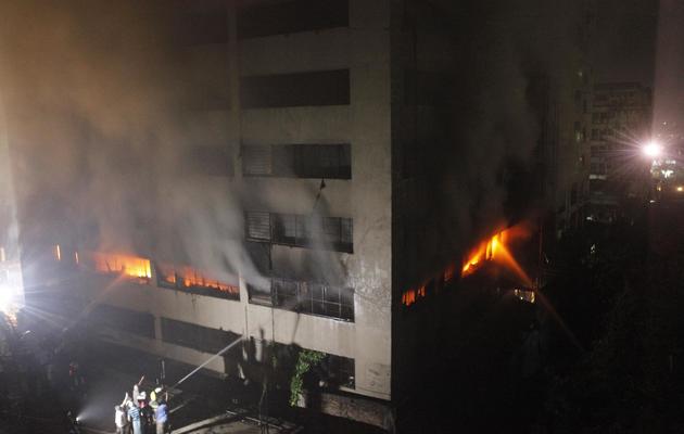 Des pompiers tentent d'éteindre un incendie dans une usine textile, à Dacca le 9 mai 2013 [ / AFP]