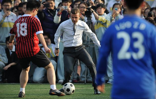 David Beckham (C) en visite à Pékin le 20 mars 2013 [Wang Zhao / AFP]