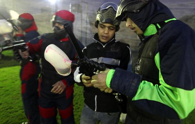 Un instructeur explique le fonctionnement des armes du paintball à des jeunes participants, le 30 novembre 2012 à Gaza [Patrick Baz / AFP]